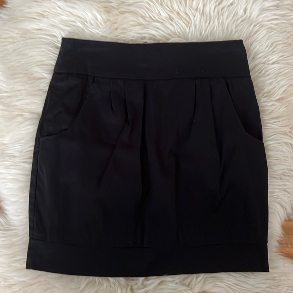 Black mini skirt with back zipper and front pockets